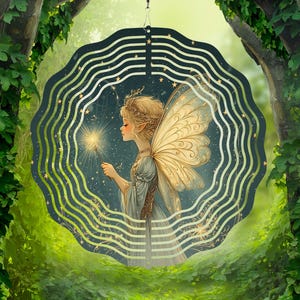 May include: A metal wind spinner with a fairy design. The fairy is holding a sparkler and has wings with gold accents. The background is a dark blue with gold stars.