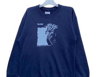 Sudadera vintage Kodak: jersey azul marino de cuello redondo con diseño gráfico de cámara