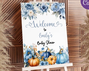 May include: A white sign on an easel with blue floral and pumpkin decorations. The sign reads "Welcome to Emily's Baby Shower." The top of the sign has blue flowers and the bottom has pumpkins in shades of blue and orange. The sign also has the text "INSTANT DOWNLOAD - EDITABLE TEMPLATE".