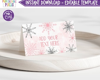 Puede incluir: Plantilla de tarjeta de lugar imprimible con diseño de copo de nieve rosa y gris con el texto "ADD YOUR TEXT HERE".