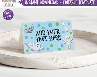May include: A blue and green printable Halloween party favor tag with a ghost, bat, mummy, and bone. The text on the tag says "Add your text here".