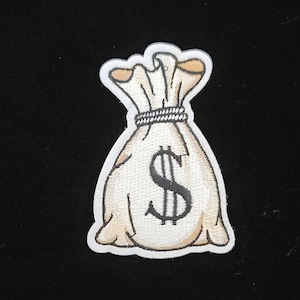 May include: A white embroidered patch of a money bag with a dollar sign on it.