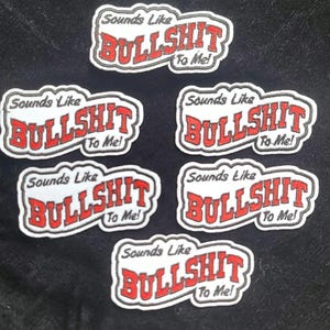May include: Six white iron-on patches with black outlines and red lettering. Each patch says "Sounds Like BULLSHIT To Me!"