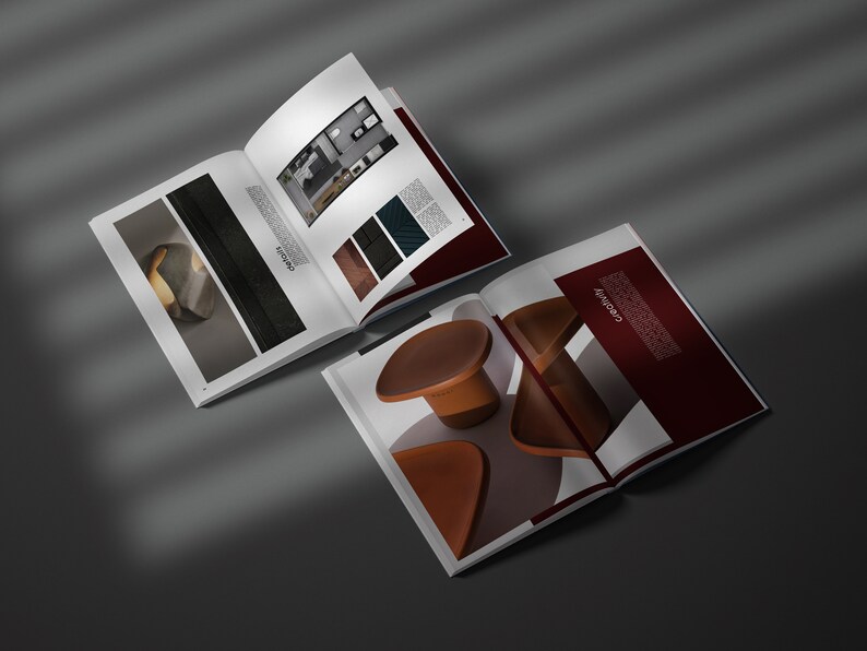 May include: Two open magazines displaying interior design concepts. One shows a room layout and material samples. The other showcases modern furniture pieces in brown and orange tones. The word "creativity" is visible on the cover.