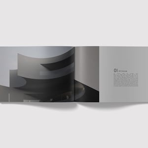 May include: An open book with a black and white photograph of a modern building on the left page. The right page has the number "01" and the text "XX House" in black.
