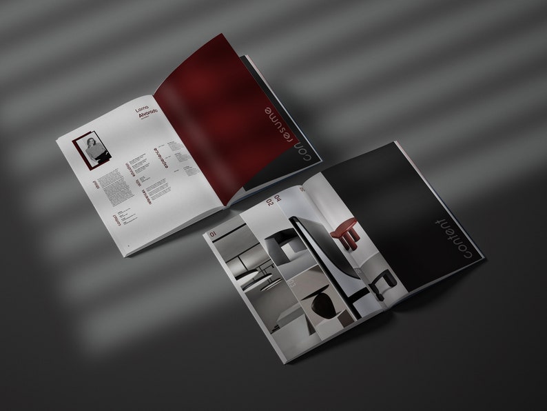May include: Two open magazines on a grey surface. One magazine displays a resume with a photo and text, the other has the word "content" on the cover. The pages inside the second magazine show interior design images.