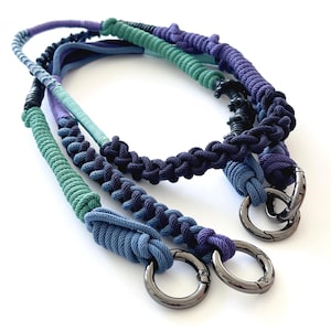 May include: Three handmade rope straps in shades of blue, green, and purple. Each strap features a metal ring clasp. The ropes are intricately woven, showcasing a variety of textures and patterns. The background is plain white.