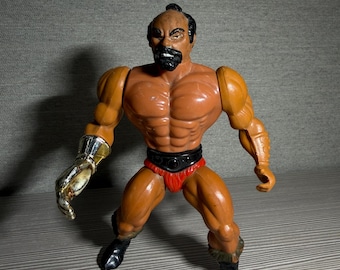 Vintage 1983 Mattel Masters of the Universe Jitsu action figure featuring a metallic gold chopping hand