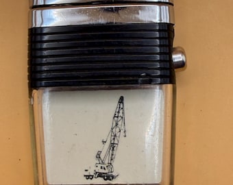 Vintage Scripto Vu-Lighter with a black band and a crane graphic in the reservoir.