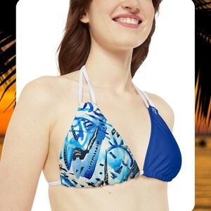 May include: A blue and white patterned bikini top with a solid blue triangle on one side and white straps.