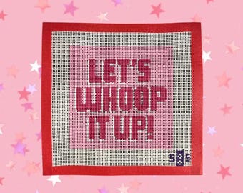 May include: A square needlepoint canvas with a red border and the phrase "LET'S WHOOP IT UP!" in pink letters. The background is a gradient of pink and white, with a small logo in the bottom right corner.