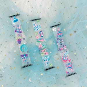 May include: Three colorful Apple Watch bands with Disney park designs. The bands feature a variety of characters and attractions, including Mickey Mouse, Cinderella's Castle, and Space Mountain.