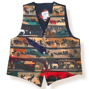 May include: A multi-colored vest with a nature-themed pattern. The vest features a black collar and back, with a front adorned with horizontal stripes of various colors and designs, including animals, trees, and wagons. It has three silver buttons and a small tag that reads "G.M.S."