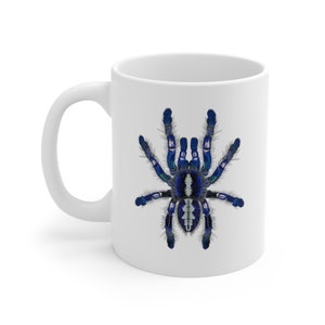 May include: White ceramic mug with a blue and white tarantula spider illustration.
