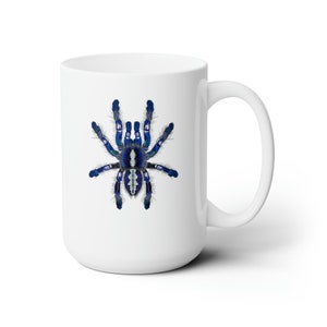 May include: White ceramic mug with a blue and white tarantula spider illustration.