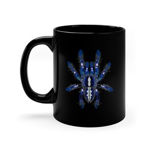 May include: Black ceramic coffee mug with a blue and white tarantula spider graphic.