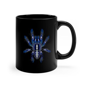 May include: Black ceramic coffee mug with a blue and white tarantula spider graphic.