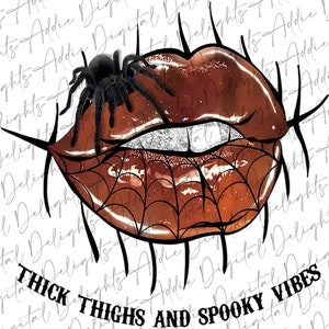 May include: A pair of glossy brown lips with a spider crawling on them. The lips are outlined in black and have a spiderweb design. The text "THICK THIGHS AND SPOOKY VIBES" is written below the lips.