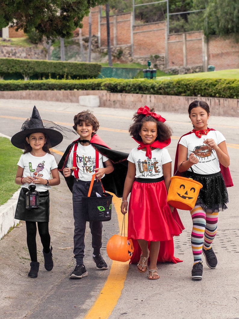 May include: Four children dressed in Halloween costumes trick-or-treating. The child on the left is wearing a witch costume with a black hat and a black dress. The child in the middle is wearing a vampire costume with a red cape and a white shirt that says "Trick or Treat". The child on the right is wearing a red dress and a white shirt that says "I Love Halloween". The child on the far right is wearing a white shirt with a pumpkin on it and a red cape.