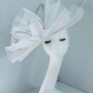 Ascot ladies race day occasion  headpiece statement  hat fascinator bespoke in white with silver trim, tulle  and quill feather detail
