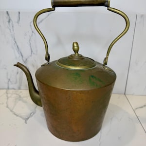 Antique brass and copper tea kettle with shaped brass handle and brass gooseneck spout with gorgeous patina. Piece shows patina, markings.