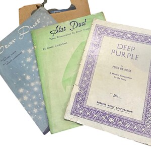 May include: Three vintage sheet music folios featuring Star Dust in blue with white stars, Star Dust in green, and Deep Purple with a purple decorative border. The covers display titles, composer names, and publisher information in black text.