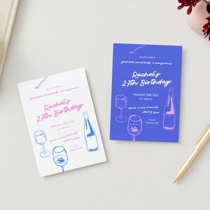 May include: Two invitations for Rachel's 27th birthday party. The invitations are printed on white and blue cardstock. The text on the invitations is in pink and blue. The invitations feature a wine bottle and glasses.