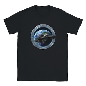 May include: A black short-sleeve t-shirt featuring a circular graphic on the chest. The design depicts a spaceship orbiting Earth with the text BC-304 U.S.S. DAEDALUS and Deep Space Defence | Fast Attack Wing printed in a metallic silver border.