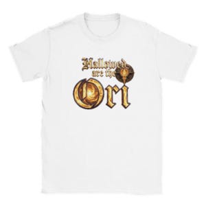 May include: A white short-sleeved t-shirt featuring a graphic print on the chest. The text reads Hallowed are the Ori in a stylized gold font, with a circular golden emblem integrated into the design above the large, bold letters of the word Ori.