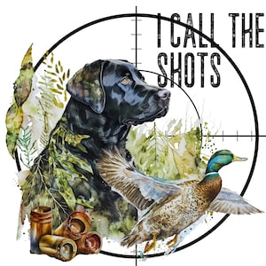 May include: A watercolor illustration featuring a black Labrador retriever, a flying mallard duck, and several shotgun shells. The design is framed by a black circular crosshair graphic with the text I CALL THE SHOTS in bold black lettering.