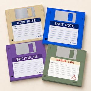 May include: Four square coasters designed like 3.5-inch floppy disks in beige, blue, purple, and olive green. Each features a label with text including DISK NOTE, SAVE NOTE, BACKUP_01, and ERROR LOG, along with lines for writing and 1.44MB text.