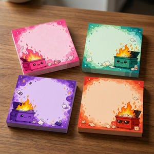 May include: Four square sticky note pads featuring cartoon dumpsters on fire. The pink pad has a smiling dumpster, the green pad has a smiling dumpster, the purple pad has a winking dumpster, and the orange pad has a dumpster wearing sunglasses.