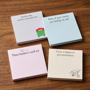 May include: Four square sticky note pads in light grey, light blue, light pink, and cream. The grey pad says Another day, another dumpster fire with a green dumpster graphic. The blue pad says None of your emails are finding me well. The pink pad says Please hesitate to reach out. The cream pad says I have a degree in procrastination with a graduation cap and diploma graphic.