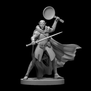 May include: A gray painted miniature figurine of a fantasy character. The character is an elf with pointed ears, wearing a cloak and holding a sword and a frying pan.
