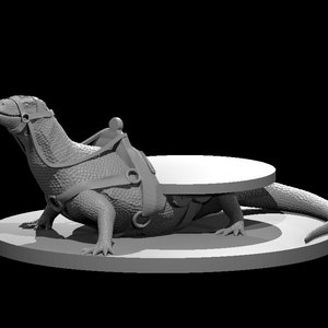 May include: A grey 3D printed model of a lizard wearing a saddle and standing on a round base.