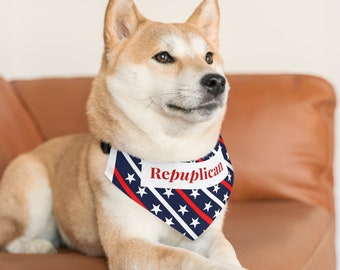 May include: A Shiba Inu dog wearing a blue, red, and white bandana with white stars and the word "Republican" printed on it.