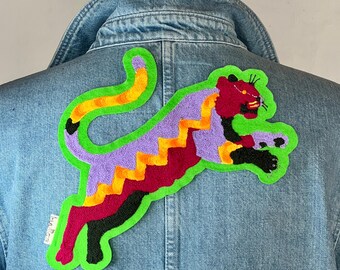 Embroidered iron-on tiger patch — multicolored leaping tiger on green felt
