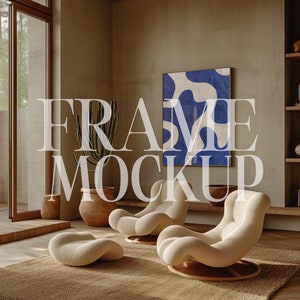 May include: A living room interior with two white lounge chairs, a brown rug, and a potted cactus plant. A framed abstract painting with blue and white colors hangs on the wall.