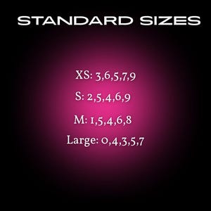 May include: A black and pink gradient background with white text. The text reads "STANDARD SIZES" at the top. Below are nail sizes: XS, S, M, and Large, each with a corresponding set of numbers. The bottom text states instructions will be provided.