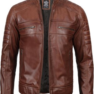 May include: A brown leather jacket with a zipper closure and multiple pockets. The jacket has a stand-up collar and a quilted design on the shoulders and sleeves.