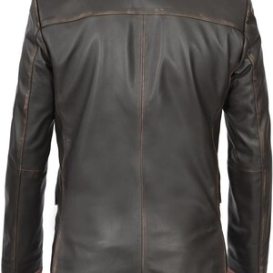 May include: A brown leather blazer with a distressed look. The blazer has a single-breasted closure and two front pockets.