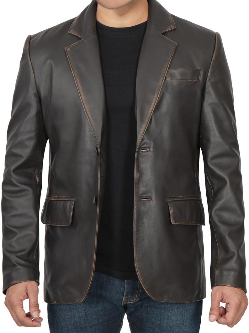 May include: A brown leather blazer with a distressed look. The blazer has a notched collar, two button closure, and two front pockets.