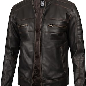 May include: A brown leather motorcycle jacket with a zipper closure and multiple pockets. The jacket has a distressed look with visible stitching.