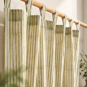 May include: Green and white striped curtains hanging from a wooden rod. The curtains have a vertical stripe pattern and are made of a light-colored fabric. The rod is a natural wood color, and the curtains are hanging in front of a window.