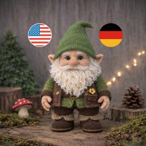 May include: A handmade crochet gnome doll, featuring a green hat, jacket, and trousers. The gnome has a long white beard, rosy cheeks, and a small yellow flower on the jacket. It stands on a wooden surface with a mushroom and pinecone nearby.