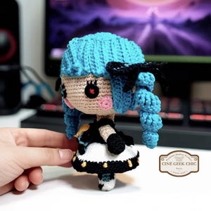 ✂️🧵 Bring the magic of threads and scissors to life with this Gwen-inspired crochet plush, a handmade tribute to the seamstress champion from League of Legends.

Crafted in two options — a 6-inch doll for your desk or display shelf, and a tiny 3-inch keychain for your bag, keys, or car — this doll features Gwen’s signature blue hair, doll-like eyes, and iconic outfit details. A whimsical and elegant gift for any LoL fan!