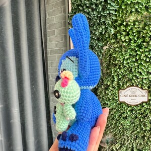 Bring home a fan-favorite duo with this handmade crochet Stitch and Scrump-inspired doll set! Carefully handcrafted with love and soft acrylic yarn, this adorable pair captures the charm of everyone's favorite blue alien and his stitched-up bestie.

Perfect as a collectible, a heartfelt gift for a Stitch lover, or a whimsical piece of decor. Each doll is crafted with attention to detail, from Stitch's signature big ears to Scrump’s button eye and sweet expression. Experiment 626 !