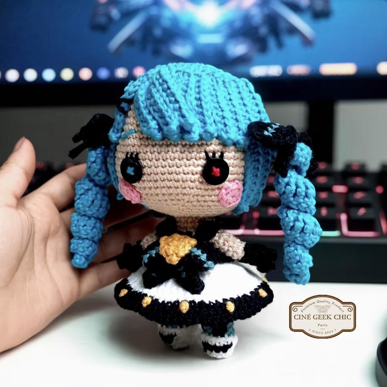 ✂️🧵 Bring the magic of threads and scissors to life with this Gwen-inspired crochet plush, a handmade tribute to the seamstress champion from League of Legends.

Crafted in two options — a 6-inch doll for your desk or display shelf, and a tiny 3-inch keychain for your bag, keys, or car — this doll features Gwen’s signature blue hair, doll-like eyes, and iconic outfit details. A whimsical and elegant gift for any LoL fan!