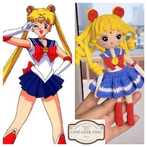 May include: A crocheted Sailor Moon doll with yellow hair, a red bow, and a blue skirt. The doll is holding a red heart in its hand. The doll is standing on a white surface.
