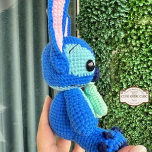 Bring home a fan-favorite duo with this handmade crochet Stitch and Scrump-inspired doll set! Carefully handcrafted with love and soft acrylic yarn, this adorable pair captures the charm of everyone's favorite blue alien and his stitched-up bestie.

Perfect as a collectible, a heartfelt gift for a Stitch lover, or a whimsical piece of decor. Each doll is crafted with attention to detail, from Stitch's signature big ears to Scrump’s button eye and sweet expression. Experiment 626 !